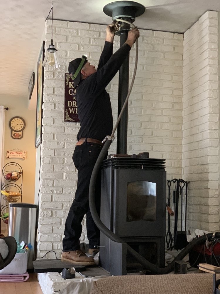 Will Mudd cleaning a chimney vent